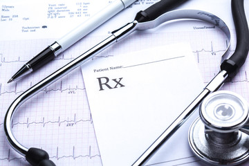 Empty prescription  lying on table with stethoscope