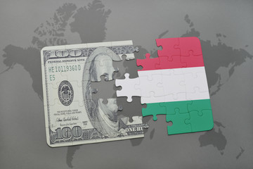 puzzle with the national flag of hungary and dollar banknote on a world map background.