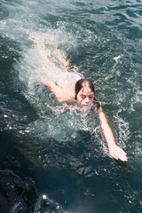 Young woman swimming in ocean