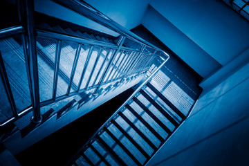 stairs in office building,blue toned image,spiritual concept.