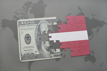 puzzle with the national flag of latvia and dollar banknote on a world map background.