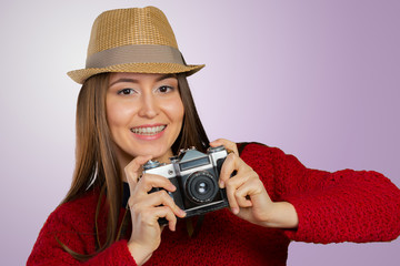 Cheerful young woman with camera