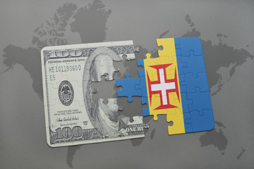 puzzle with the national flag of madeira and dollar banknote on a world map background.