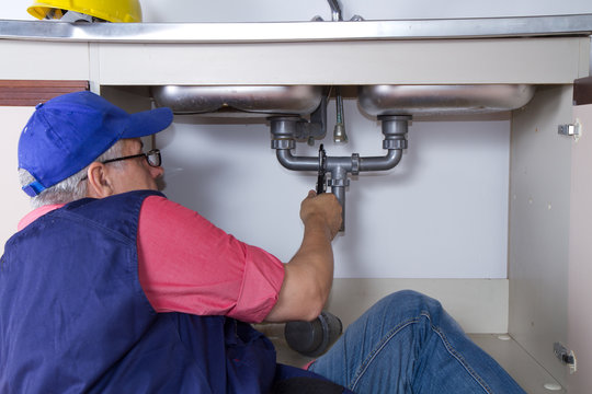 plumber at work with a sink