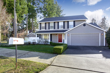 Blue gray house with french windows and red entrance door