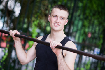  Athletic Man doing exercise with bar