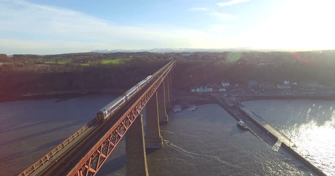 Aerial: Train on Forth Rail Bridge in Queensferry, Edinburgh, Scotland