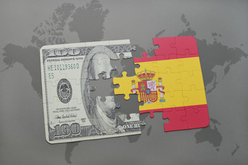 puzzle with the national flag of spain and dollar banknote on a world map background.