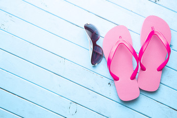 Pink flip flops and sunglasses.