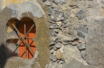 Barred window in wall, Funchal, Madeira, Portugal