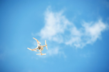Drone quadrocopter with digital camera in blue sky. 