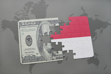 puzzle with the national flag of indonesia and dollar banknote on a world map background.