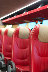 Fototapeta premium Empty red leather seats in tourist bus.