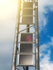 Vertical solar panels over blue sky.