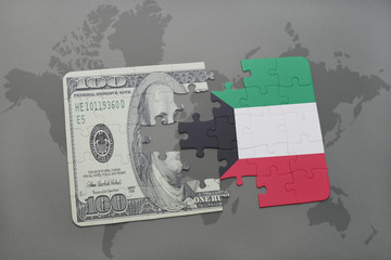 puzzle with the national flag of kuwait and dollar banknote on a world map background.