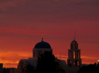 Beautiful Orange and Purple Sunset Afterglow over Cyclades Style Church, Santorini Island of Greece