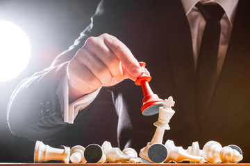 Hand of businessman playing chess