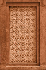 Decorative stone panel on the wall on facade of the building. In