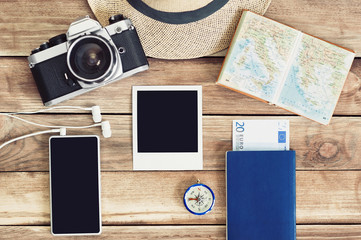 Accessories for travel. Passport, photo camera, smart phone and travel map. Top view. Holidays and...