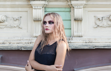 Fototapeta na wymiar An outdoor fashion gothic style portrait of a beautiful blonde girl