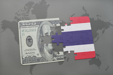 puzzle with the national flag of thailand and dollar banknote on a world map background.