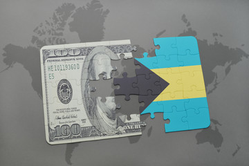 puzzle with the national flag of bahamas and dollar banknote on a world map background.