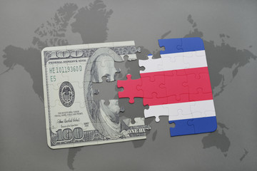 puzzle with the national flag of costa rica and dollar banknote on a world map background.