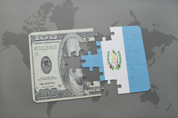 puzzle with the national flag of guatemala and dollar banknote on a world map background.