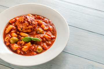 Portion of minestrone soup with meatball