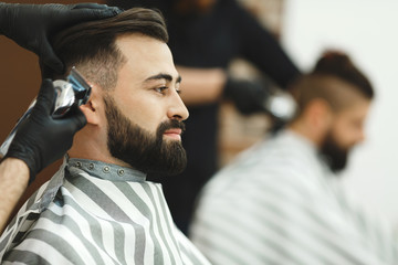 Man with dark hair doing a haircut