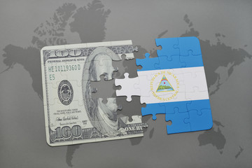 puzzle with the national flag of nicaragua and dollar banknote on a world map background.
