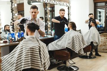 Men at barber shop doing haircuts