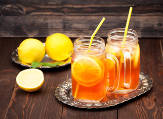 Iced tea with lemon in a glass jars