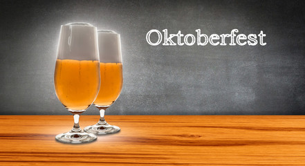 two glasses beer before chalkboard