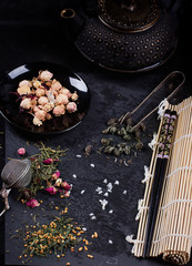 Variety of dry tea with teapot