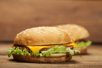 Fresh burgers on wooden background