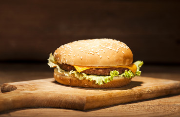 Fresh burger on wooden background