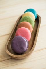 Macarons on wooden table and vintage color tone