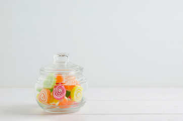 Colorful candies in transparent jar