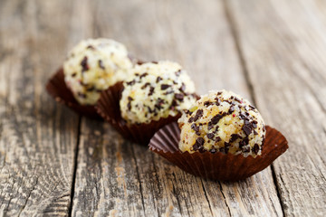 Delicious vegetarian truffle candies on wodden table.