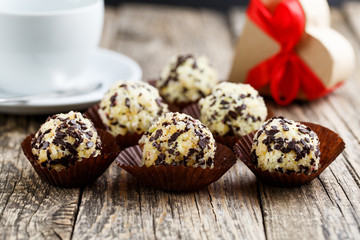 Delicious vegetarian truffle candies on wodden table.