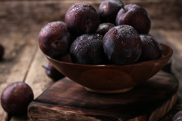 ripe plums on wooden vintage background