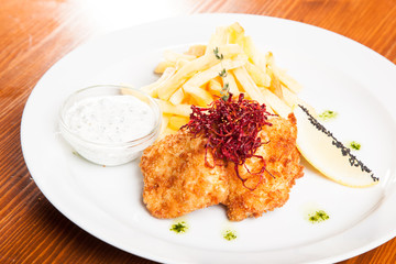 dish of meat in batter and fried potatoes