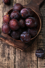 ripe plums on wooden vintage background