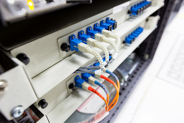Fiber optic cable connect to ethernet switch mount on rack.