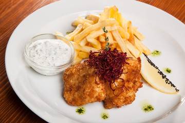 dish of meat in batter and fried potatoes