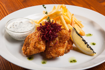 dish of meat in batter and fried potatoes