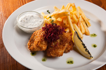 dish of meat in batter and fried potatoes
