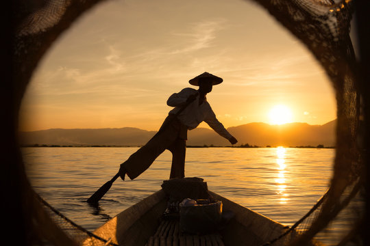 Man wearing conical hat on boat, Myanmar