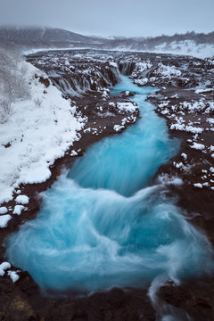 Long exposure image of river flowing on snow covered landscape